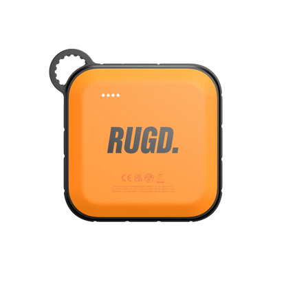 RUGD Power Brick I, an orange camping power bank with charging indicators and a loop for easy carrying.